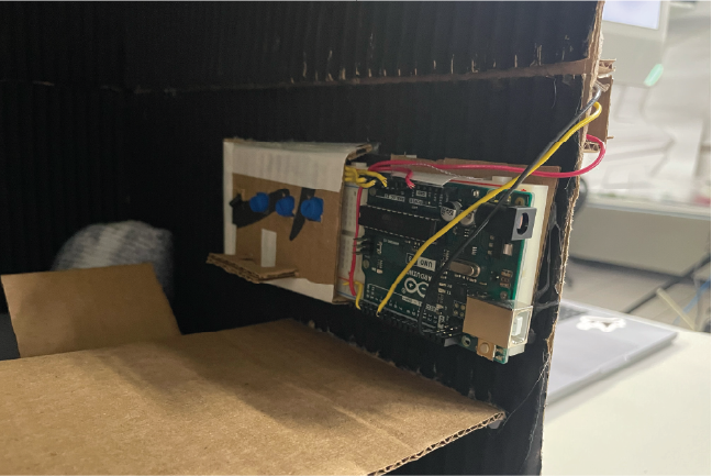 I encased the Arduino and the rest of the inputs into a cardboard casing. I made the casing so then I could hot glue the Arduino to the side of the room.